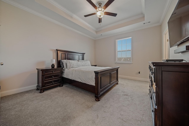 carpeted bedroom with crown molding, ceiling fan, and a tray ceiling