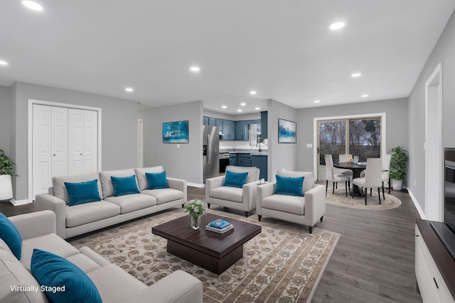 living room with hardwood / wood-style flooring and sink