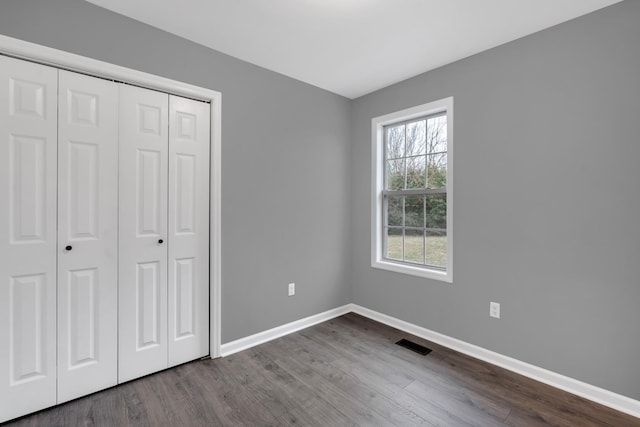 unfurnished bedroom featuring a closet and wood-type flooring