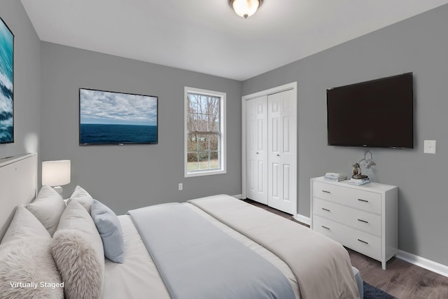 bedroom with dark wood-type flooring and a closet