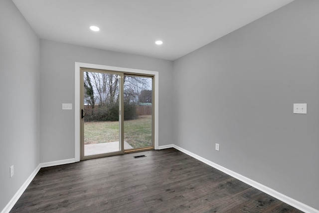 empty room with dark hardwood / wood-style flooring