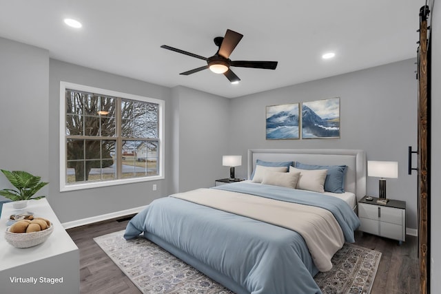 bedroom with ceiling fan and dark hardwood / wood-style floors