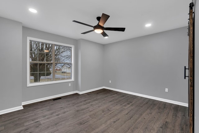 empty room featuring ceiling fan and dark hardwood / wood-style flooring