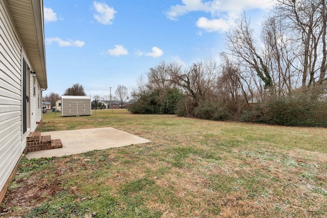 view of yard featuring a storage shed and a patio