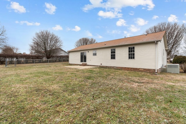 rear view of house with central air condition unit, a patio, and a yard