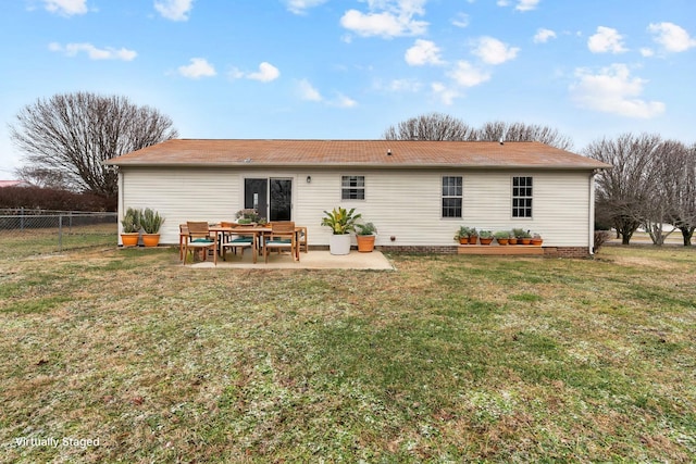 back of property with fence, a yard, and a patio area
