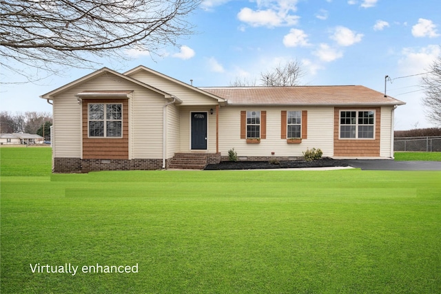 view of front of house with fence, roof with shingles, crawl space, and a front yard