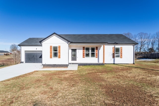 view of front of house featuring a garage, a front yard, and a porch