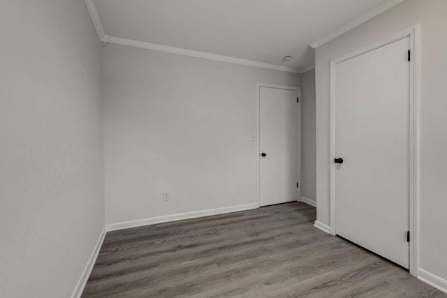 empty room with ornamental molding and light hardwood / wood-style flooring