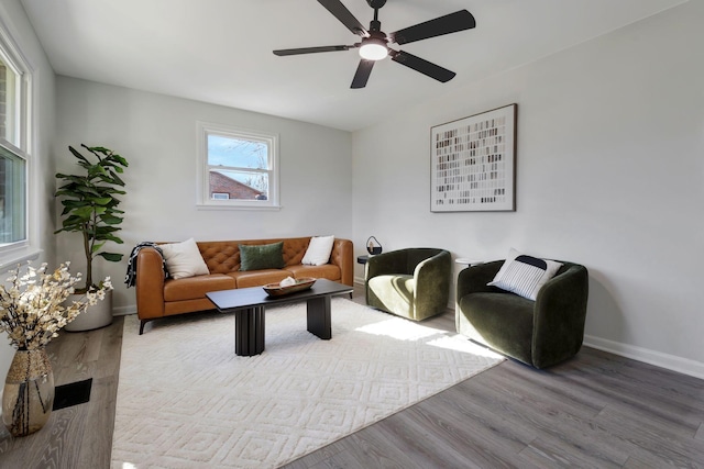 living room with ceiling fan and light hardwood / wood-style flooring