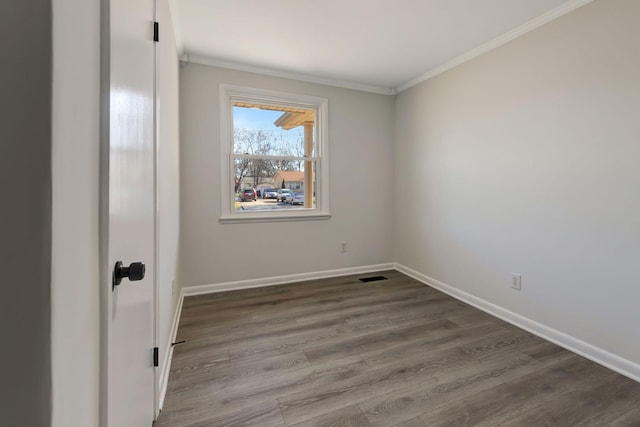 spare room with hardwood / wood-style floors and ornamental molding