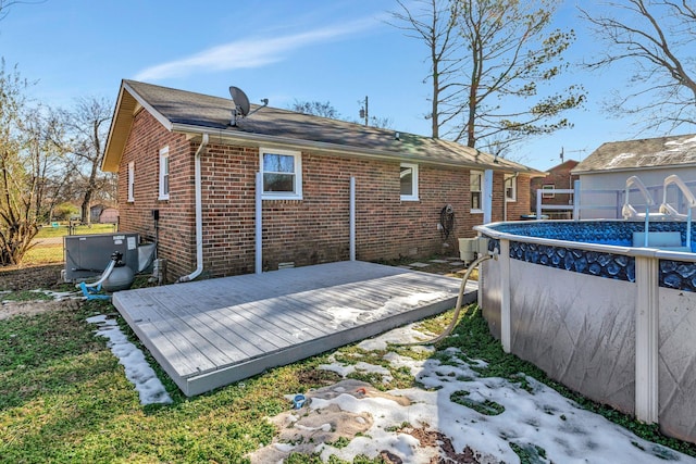 rear view of property featuring a swimming pool side deck