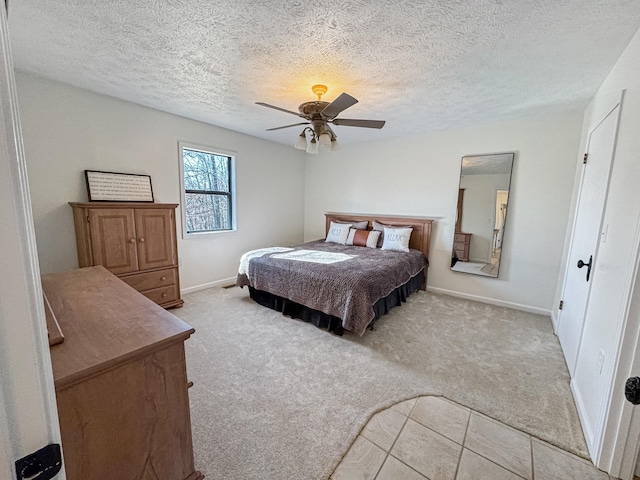 carpeted bedroom featuring a textured ceiling and ceiling fan