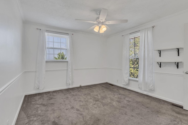 carpeted spare room featuring ceiling fan, a textured ceiling, and ornamental molding