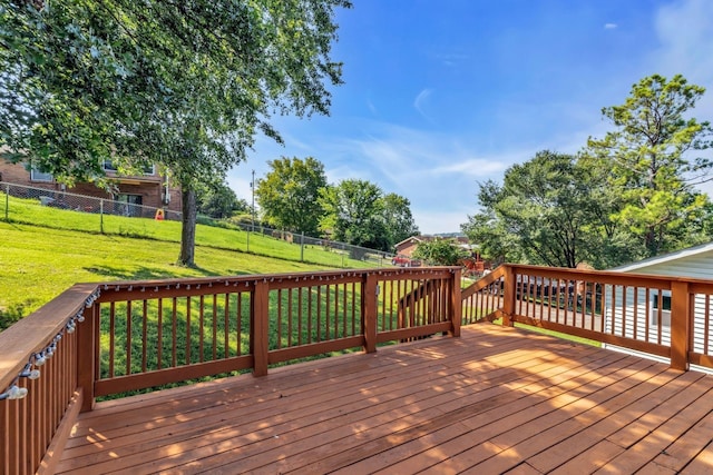 wooden deck featuring a yard