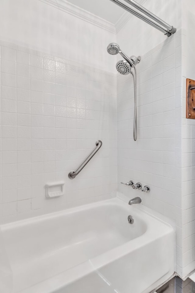 bathroom featuring ornamental molding and tiled shower / bath combo