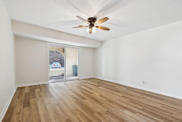 spare room featuring light wood-type flooring and ceiling fan