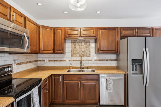 kitchen featuring sink, appliances with stainless steel finishes, and tasteful backsplash