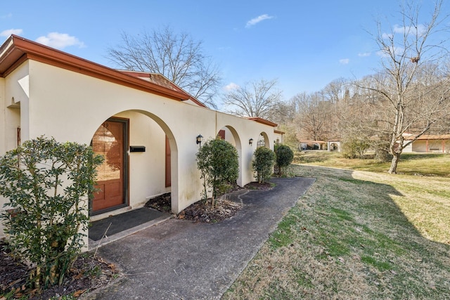 view of property exterior with a lawn