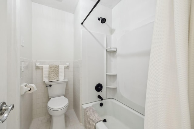 bathroom featuring shower / bath combo, toilet, tile patterned floors, and tile walls