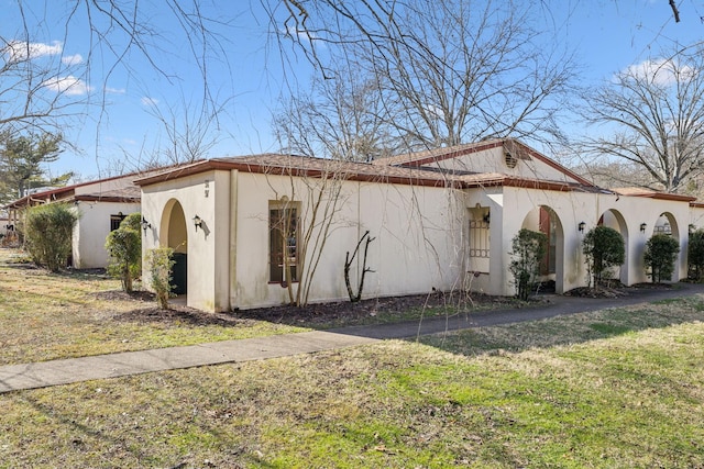 view of home's exterior with a lawn