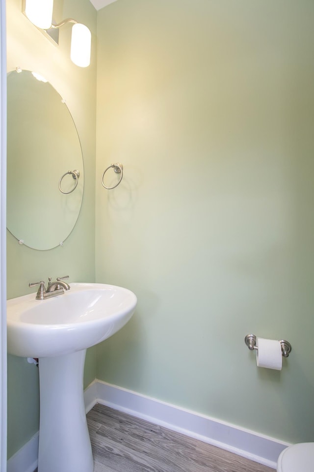 bathroom with hardwood / wood-style flooring