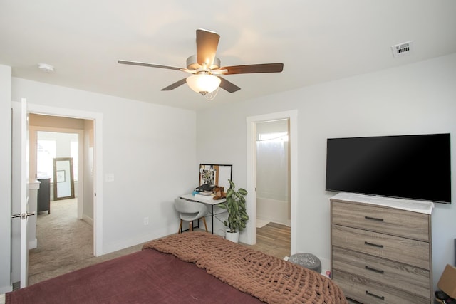 carpeted bedroom featuring ceiling fan and connected bathroom