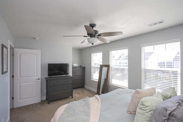 bedroom with ceiling fan and light colored carpet