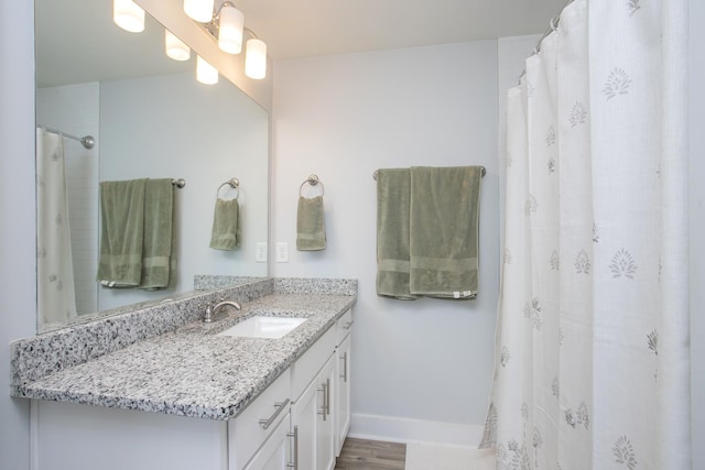 bathroom featuring wood-type flooring and vanity