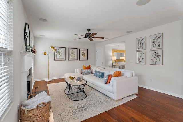 living room featuring ceiling fan, plenty of natural light, and dark hardwood / wood-style floors