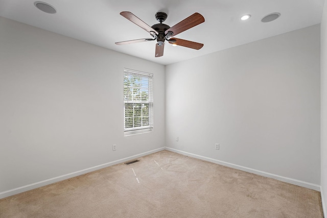 carpeted spare room featuring ceiling fan