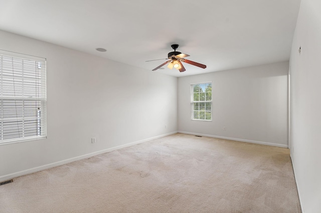 carpeted empty room featuring ceiling fan