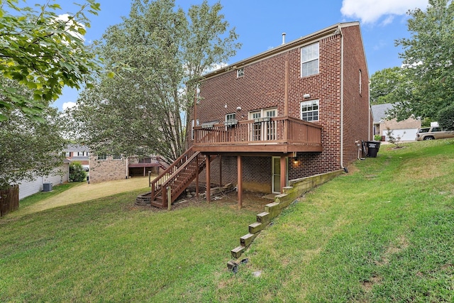 back of house featuring a wooden deck and a lawn