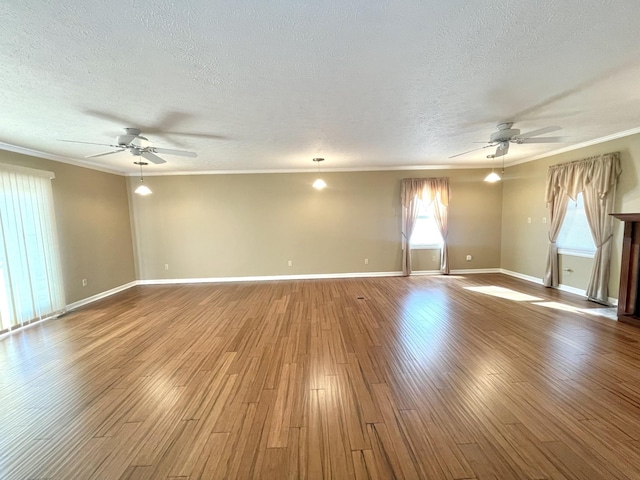 unfurnished room featuring ceiling fan, a textured ceiling, crown molding, and light wood-type flooring