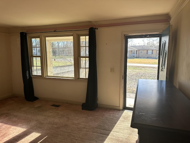 doorway to outside featuring crown molding and carpet floors