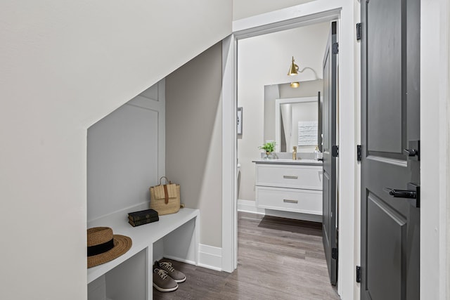 mudroom with wood-type flooring and sink