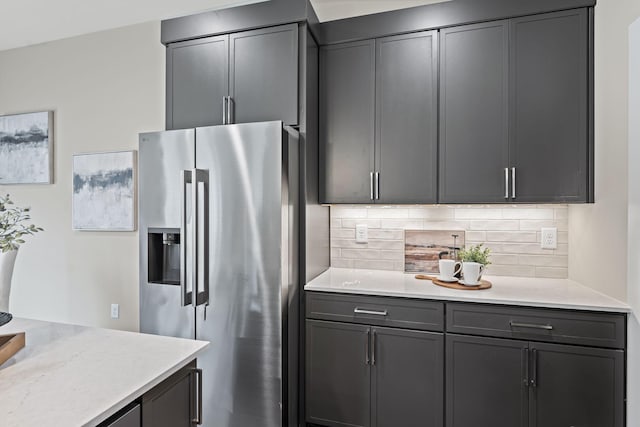 kitchen featuring backsplash and high end refrigerator