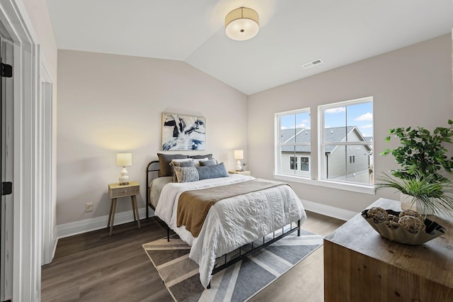 bedroom with dark hardwood / wood-style flooring and vaulted ceiling