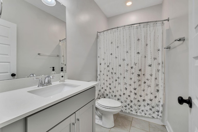 bathroom with tile patterned flooring, vanity, and toilet