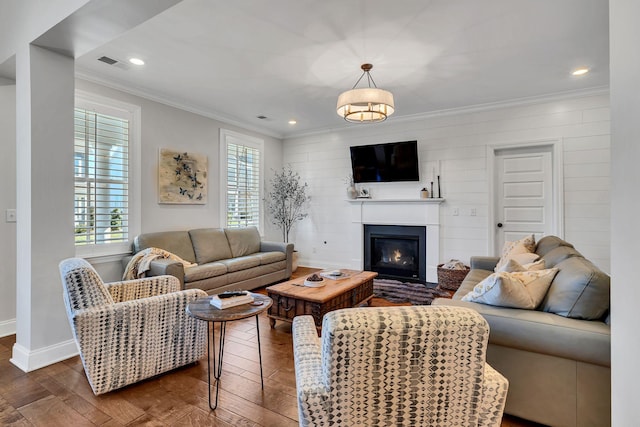 living room featuring dark hardwood / wood-style flooring and ornamental molding