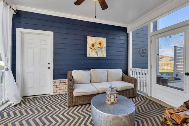 living room featuring ornamental molding and ceiling fan