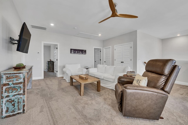 carpeted living room featuring ceiling fan