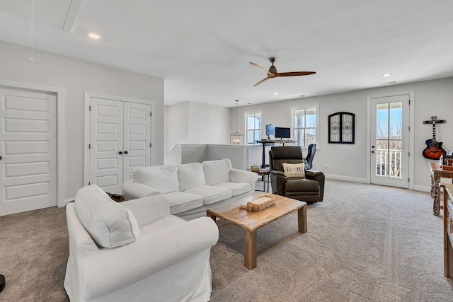 living room featuring carpet flooring and ceiling fan