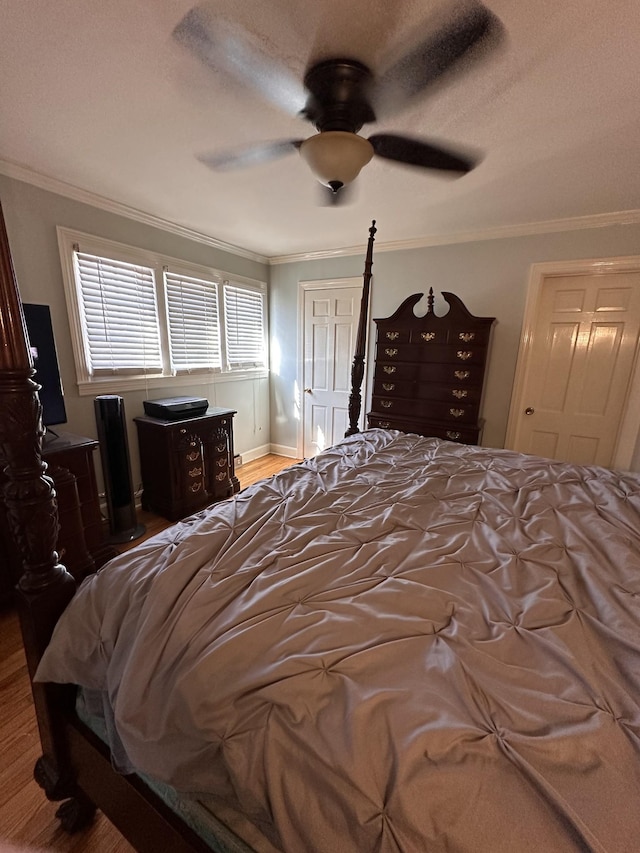 bedroom featuring ceiling fan, crown molding, and hardwood / wood-style flooring