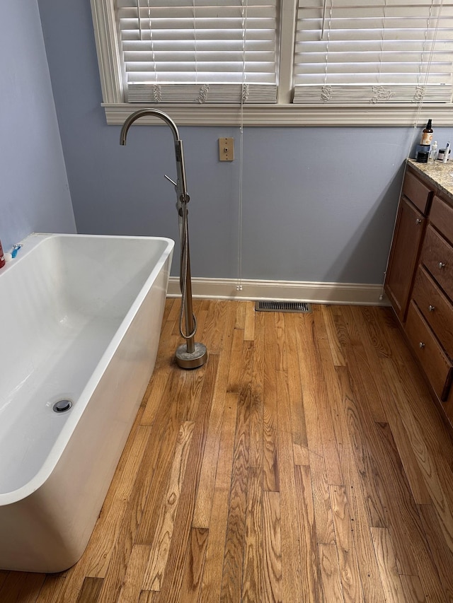 bathroom with vanity and hardwood / wood-style flooring