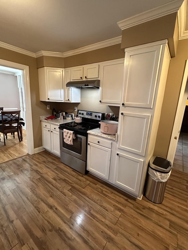 kitchen featuring electric stove, light stone countertops, dark wood-type flooring, ornamental molding, and white cabinets