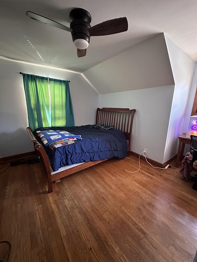 bedroom with ceiling fan, hardwood / wood-style floors, and vaulted ceiling