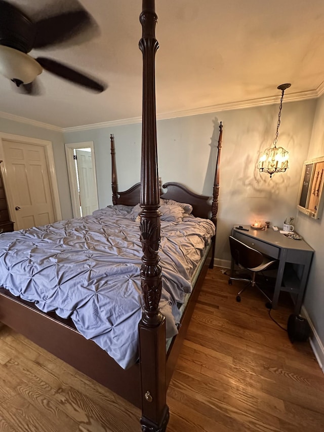 bedroom with crown molding, wood-type flooring, and ceiling fan with notable chandelier