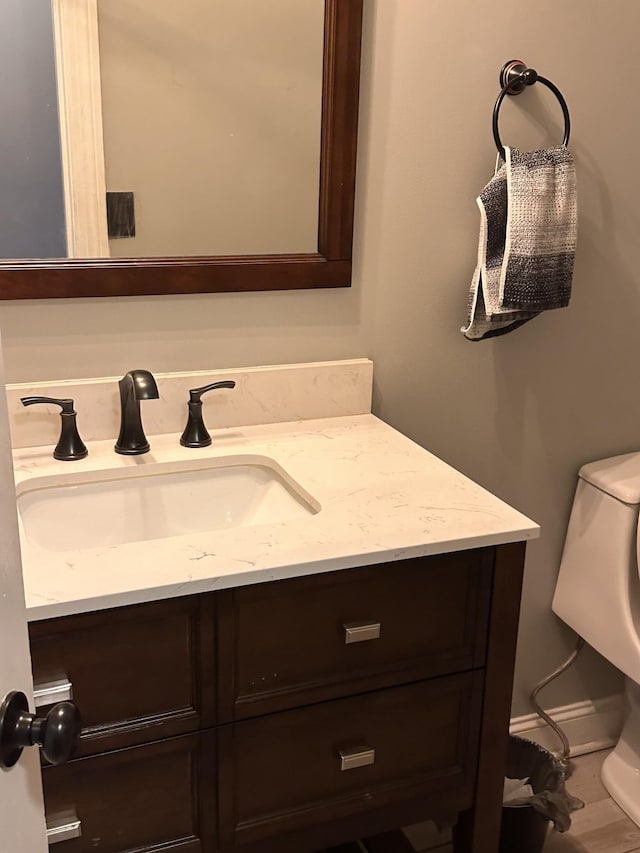 bathroom featuring toilet and vanity