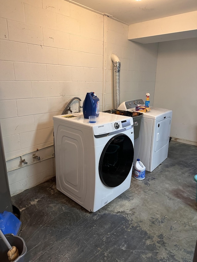 clothes washing area with independent washer and dryer